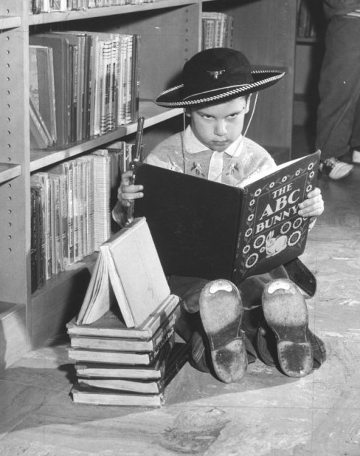 Child in a library with gun